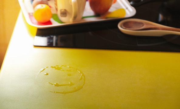 An smile drawn with water on kitchen worktop next to breakfast tray