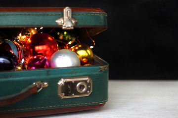 toys for adults decorations for the holiday in a suitcase on a dark background
