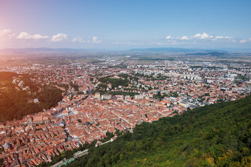 Landscape of european old city Brasov from peak of mountains with sunlight