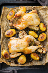 Roasted chicken with spices, herbs, garlis, small potatoes