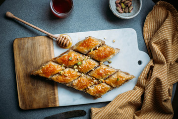  Perfect sweet baklava with pistachio on marble background