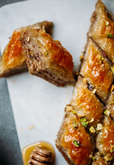  Perfect sweet baklava with pistachio on marble background