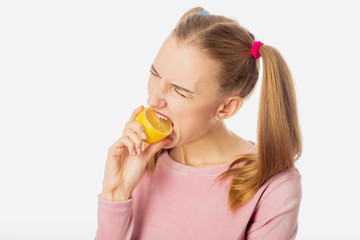 girl eats lemon