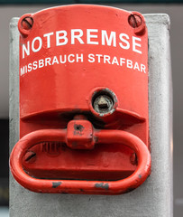 Red emergency brake to stop a large rolling staircase, with German inscription 