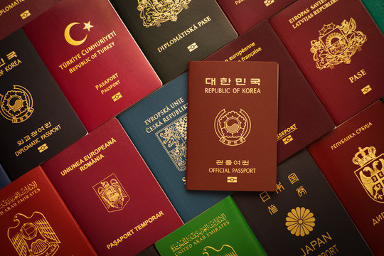 Brown official passport of the Republic of Korea against the background of many passports from around the world