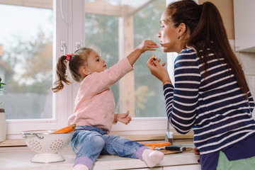 Mother and daughter preparing lunch in kitchen