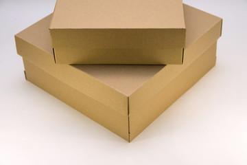 two cardboard boxes lie one on the other on a white background