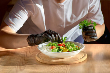 Chef hands preparing vegetable salad. copy space