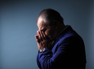 Beautiful older man in front of a colored background