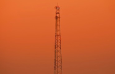Communication tower with antennas, Cellphone Tower, Phone Pole over a colored Sunset