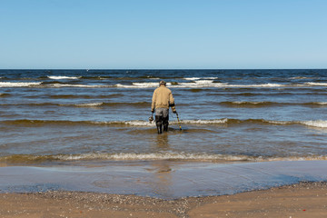 man on the beach looking for gold