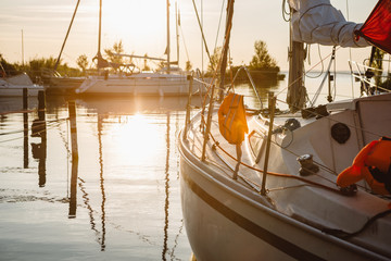 Obraz premium Detail of boat railing on yacht anchored on calm surface of hungarian lake Balaton known also as Hungarian Sea during the summer golden sunrise