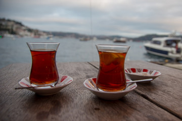 two thin specific cups of tea waiting to be drink on wooden table