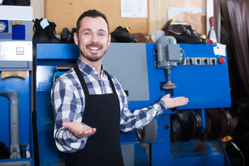 Laughing worker showing his workplace and tools