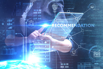 Fototapeta premium The concept of business, technology, the Internet and the network. A young entrepreneur working on a virtual screen of the future and sees the inscription: Recommendation