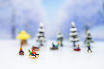 Miniature people: Children playing on snow funny together. Image use for Christmas festival