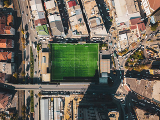 aerial view of a football field in residental area. top view of football pitch