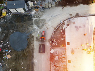 Aerial top view of a truck and construction worker at construction site