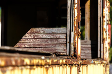 Wooden chair in old rusted abandoned tram.