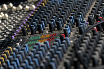 Fototapeta premium Close up shot of a mixer desk with many knobs