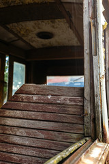 Fototapeta na wymiar Wooden chair in old rusty destroyed tram.
