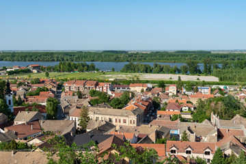 Sremski Karlovci, Serbia - May 2, 2018: Panorama of Sremski Karlovci. Panoramic view of the roofs of the house, Danube river, train and railroad.