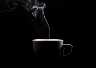 Fragrant coffee on a black background for your advertising. Smoke from hot coffee.