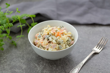Russian salad in white bowl. National cuisine. Russian traditional salad Olivier for New Year party.