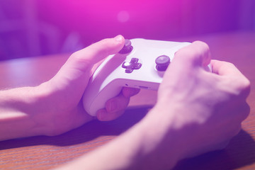 hands holding a joystick and play video games at home in the night f © Mihail