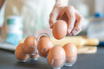 close up cook hands taking an egg while cooking f