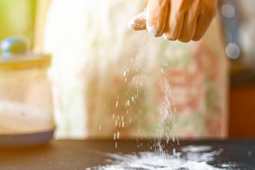 cook hand pour the flour on table f