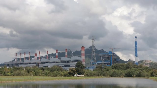beautiful clouds sunbeams and beautiful landscape time lapse at power plant

