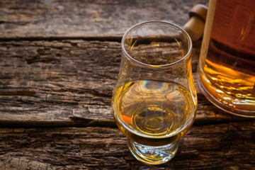 glencairn whiskey glass with single malt whiskey with space for text on a wooden background