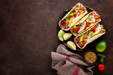Mexican tacos with chicken meat, vegetables and fresh greens