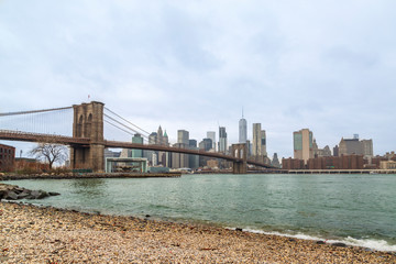 Brooklyn bridge and lower manhattan from peddle  beach in Brooklyn, New York, USA