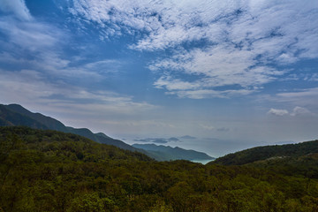 Fototapeta na wymiar landscape view of sea and tree mountain in blue sky day