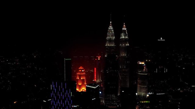 Aerial view of Kuala Lumpur at night, modern city with skyscrapers - landscape panorama of capital city of Malaysia from above, Asia