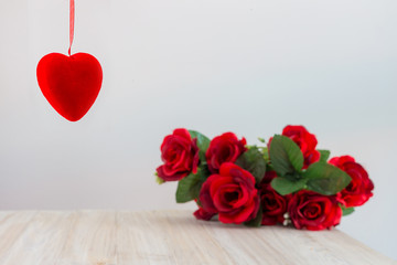 Red heart Hanging and a Blurred Bouquet of Roses
