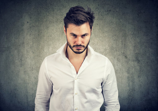 Offended young man looking at camera