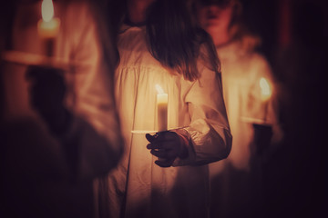 Kids are handling candles in the traditionall dresses. Celebration of Lucia day in Sweden.