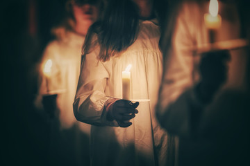 Kids are handling candles in the traditionall dresses. Celebration of Lucia day in Sweden.