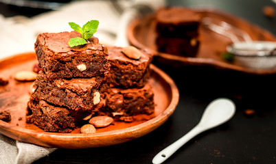 pyramid of freshly prepared home fresh brownies with nuts and figs, on a black background