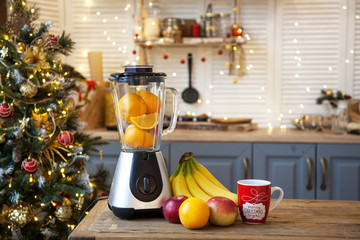Christmas in the kitchen.Blender with fruit on the table