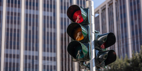 Red traffic lights for cars, office buildings background