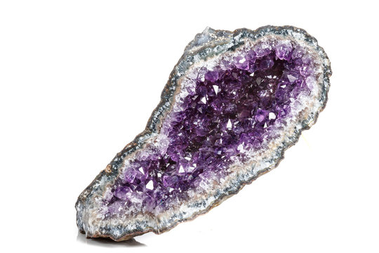 Macro Mineral Stone Amethysts in the rock on a white background