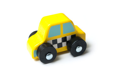closeup of miniature wooden car on white background - concept taxi