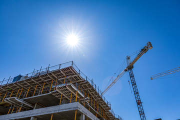 Fototapeta na wymiar Construction site crane and sunny sky