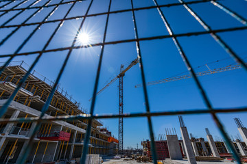 Naklejka premium Construction site crane and sunny sky