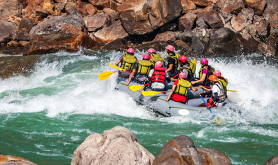 Young persons rafting on the river Ganges in Rishikesh, extreme and fun sport at tourist attraction