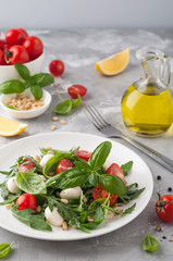 Healthy salad with cherry tomatoes, arugula and mozzarella. Home made food. Concept for a tasty and healthy appetizer. Selective focus.